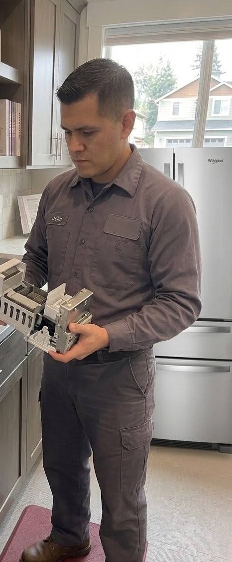 Refrigerator ice maker module examined in hand